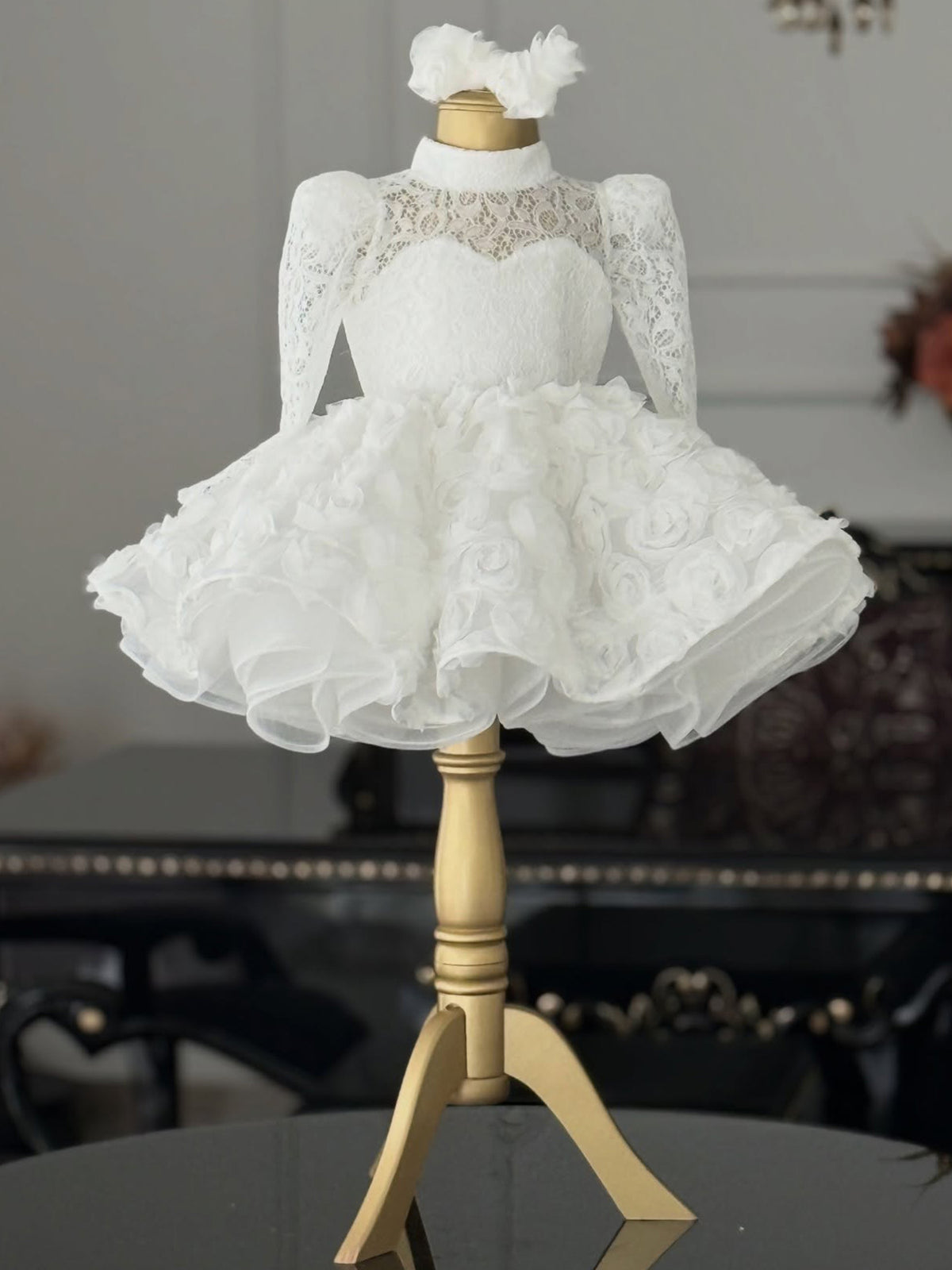 White lace girls princess dress with long sleeves and full rosette skirt, designed for first birthday photos.
