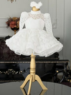 White lace girls princess dress side view with puffed shoulders and 3D rosette skirt, designed for weddings.