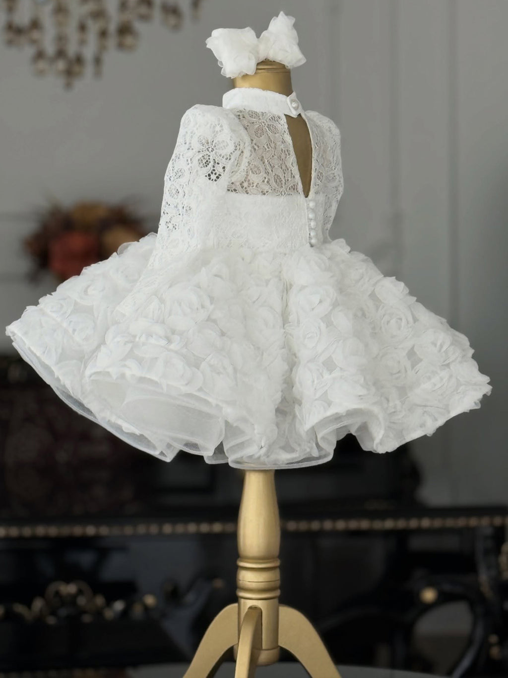 White lace girls princess dress back view with keyhole opening and button closure, designed for ceremonies.