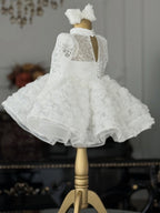 White lace girls princess dress back view with keyhole opening and button closure, designed for ceremonies.