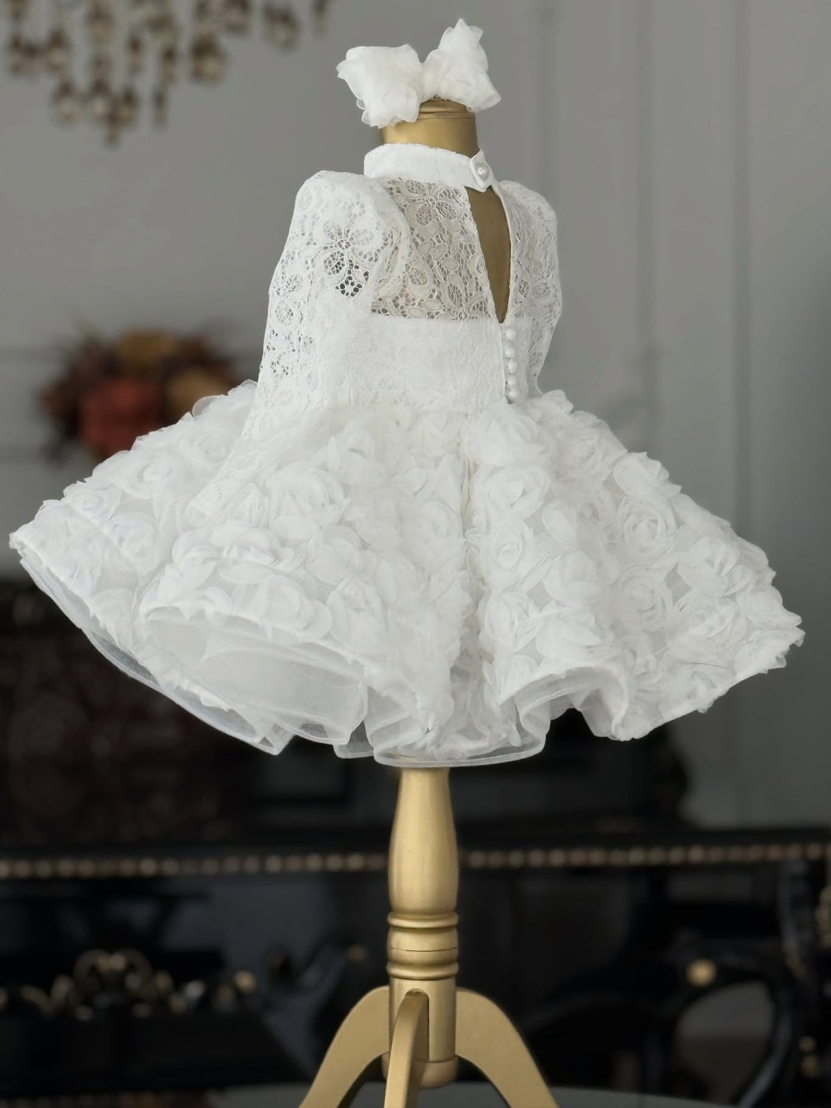 White lace girls princess dress back view with keyhole opening and button closure, designed for ceremonies.