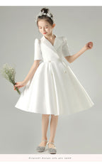 White satin girls dress with a tuxedo lapel collar, puff half sleeves and a full knee-length skirt, designed for weddings and recitals, view 11