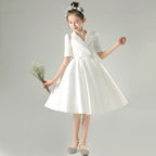 White satin girls dress with a tuxedo lapel collar, puff half sleeves and a full knee-length skirt, designed for weddings and recitals, view 4