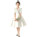 White satin girls dress with a tuxedo lapel collar, puff half sleeves and a full knee-length skirt, designed for weddings and recitals, view 5