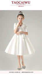 White satin girls dress with a tuxedo lapel collar, puff half sleeves and a full knee-length skirt, designed for weddings and recitals, view 7