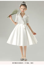 White satin girls dress with a tuxedo lapel collar, puff half sleeves and a full knee-length skirt, designed for weddings and recitals, view 8