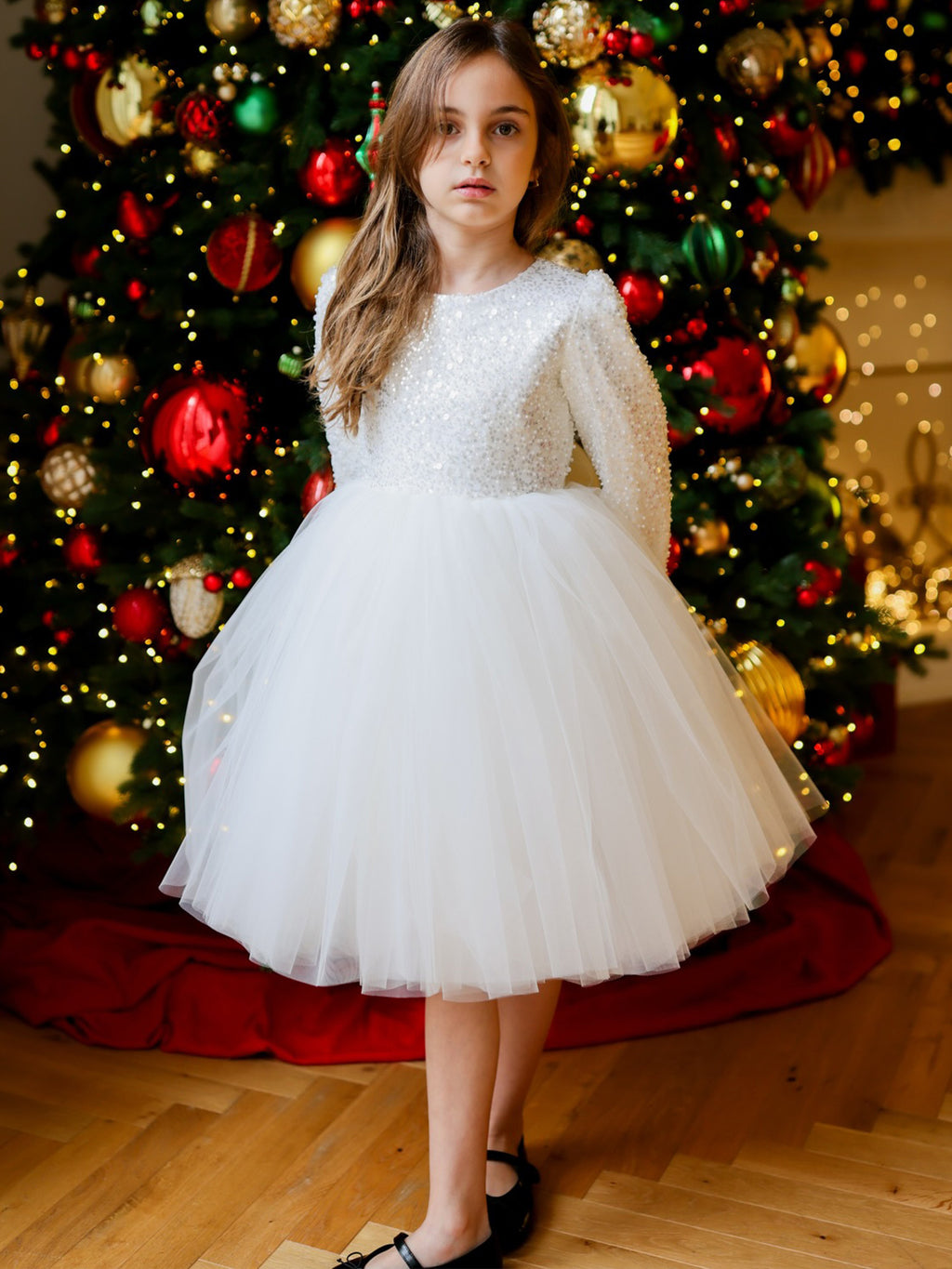 White sequin girls tutu dress with long sleeves, heart open back and satin bow, designed for Christmas and weddings.